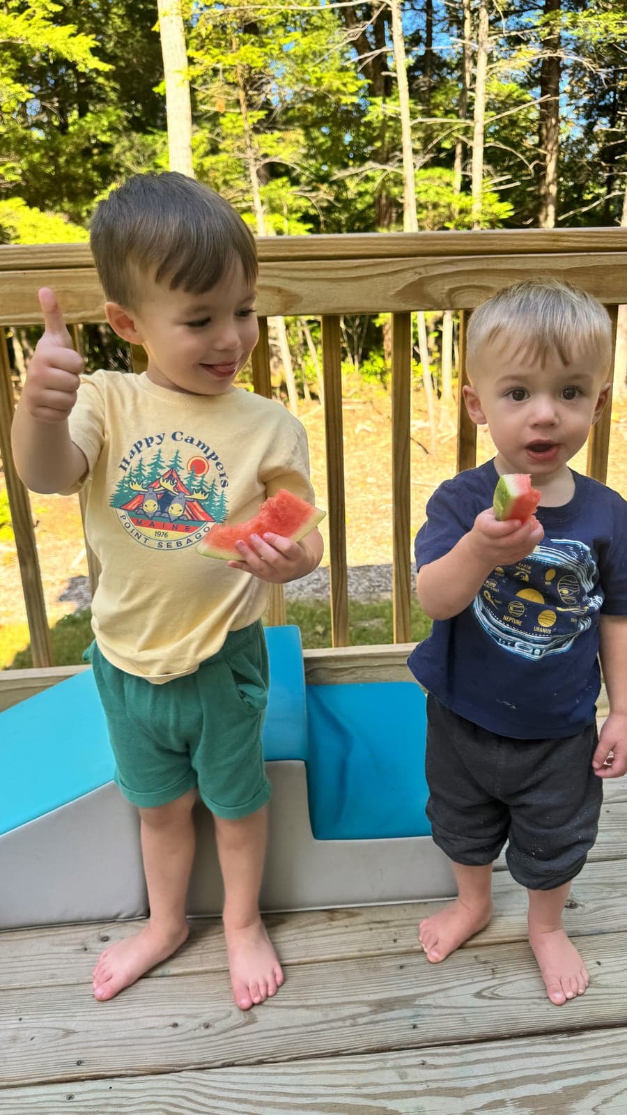 Two children enjoying watermelon on a sunny Maine afternoon